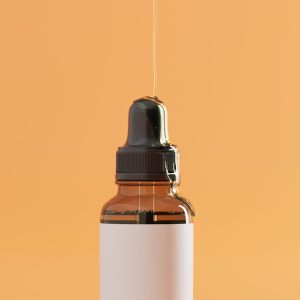 a bottle of liquid with a dropper on a yellow background